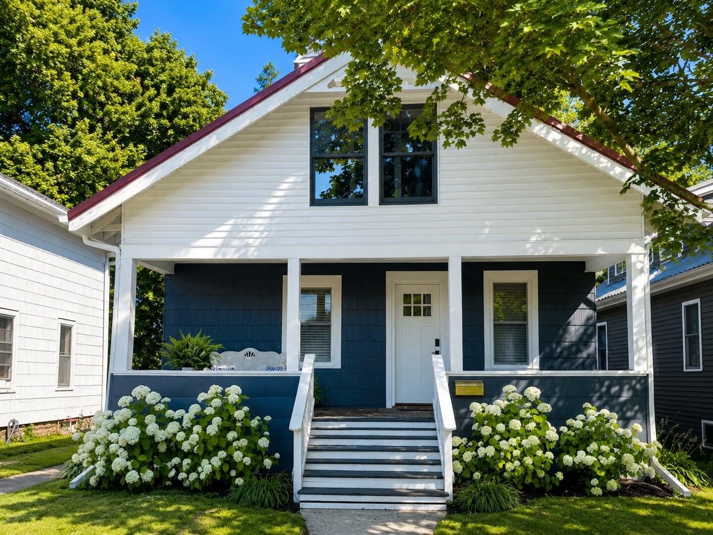 front view of blue and white bungalow style house with front porch