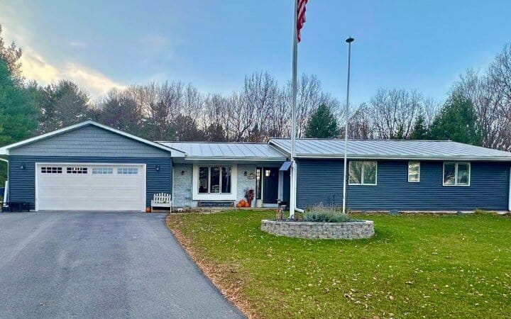 Hail Damaged Metal Roof Replacement Hortonville Ashauer blue residential home with grey metal roofing